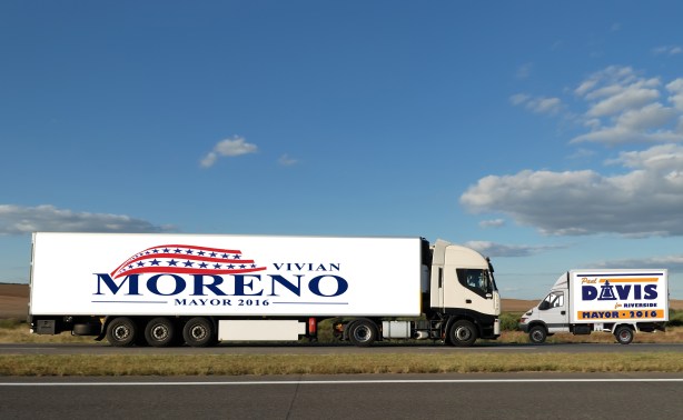 Long lorry with white truck and trailer on highway against blue sky. See my other best vans collection.